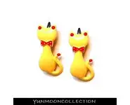 Une pair de barrettes chats en jaune